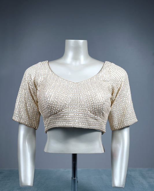 Champagne beige designer padded readymad blouse embellished with vertical sequin lines, featuring a sweetheart neckline and elbow length sleeves.