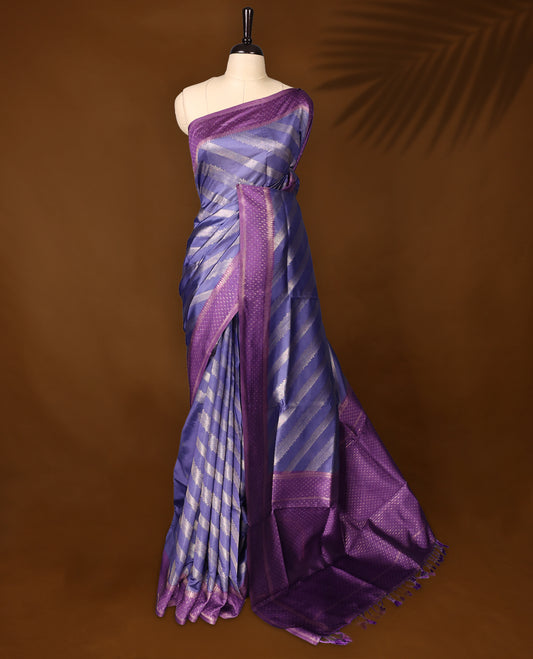 Pastel purle colour saree having fold zari stripes all over the body paired with purple colour border and matching blouse