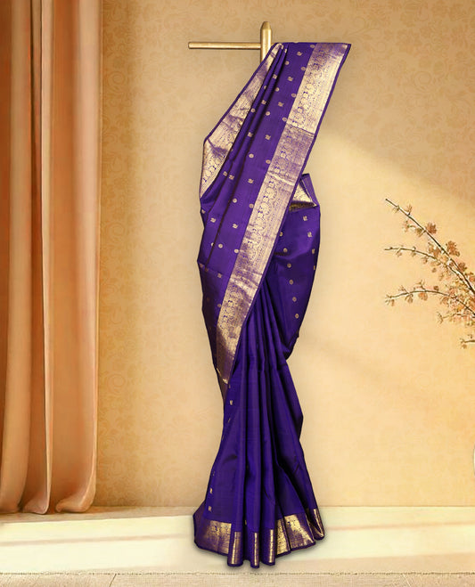 Deep violet colour pure Kancheepuram saree with gold zari Mayoora Chakra motifs on the body, traditional border featuring peacock and floral patterns, grand pallu, and paired with a matching blouse.