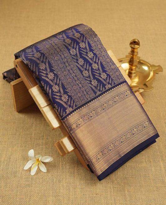 Dark violet colour Kanchipuram pattern Manthrakodi saree adorned with intricate geometrical zari floral weaving, complemented by an antique traditional zari border and a plain blouse piece with matching zari border.