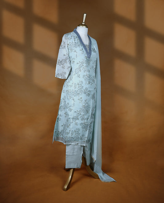 Baby blue colour salwar from TWARA, featuring a V-neck adorned with sequins and thread work, with floral prints on the top, paired with a matching bottom and dupatta.