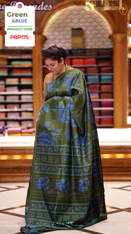 Green & Blue colour semi silk saree enhanced with a vibrant blue colour floral prints on body & pallu, and comes with a self printed blouse.
