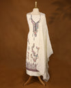 Off-white threadwork top with multi-colour prints and border, paired with a bottom and an embroidered dupatta.