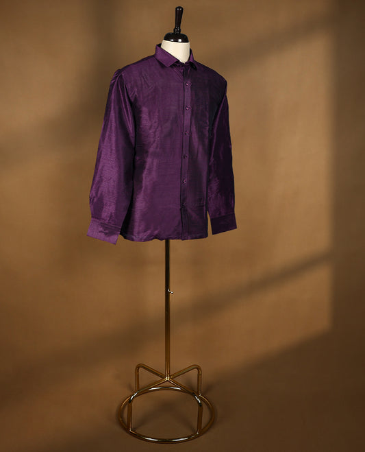 Rich wine purple colour men’s shirt in a relaxed formal fit, crafted with a glossy self textured finish, full sleeves, classic collar, and chest pocket ideal for festive or evening wear.