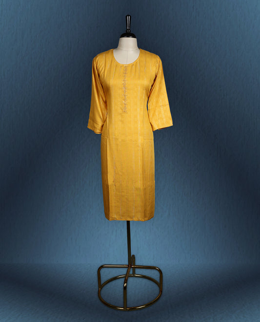 Mustard yellow colour kurti with subtle vertical self stripes, adorned with delicate thread embroidery along the front placket, featuring a round neckline and stylish three quarter sleeve