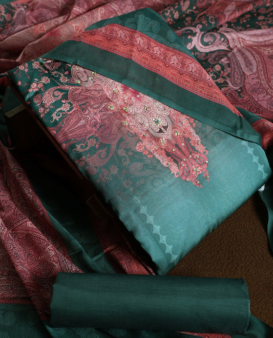 Dark green colour churidhar material featuring intricate embroidery with subtle paisley patterns, paired with a richly printed dupatta and plain bottom.