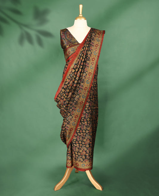 Dark colour Manipuri saree features a body filled with vibrant paisley and floral block motifs, accentuated by a multicolour floral printed border and paired with a matching blouse.