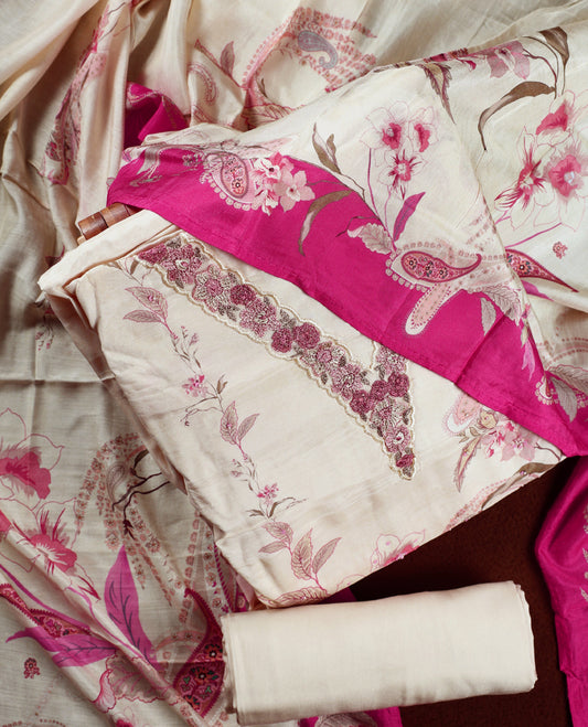 Cream colour churidhar material with pink floral and paisley prints, enhanced by a magenta border and delicate embroidery & Comes with matching plain bottom and dupatta.