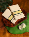 Off white colour cotton SET MUNDU featuring a plain body, complemented by deep green and gold toned border ( 2.00/2.80 MTS ).