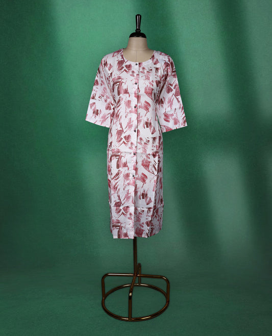 White cotton kurti with abstract Pastel maroon brushstroke prints, featuring a round neckline, front button detailing, and elbow length sleeves a stylish choice for casual daywear.