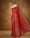 Reddish orange colour Banarasi Bandhani silk saree featuring with intricate Banarasi motifs on body, complemented by antique zari woven border and grand pallu, paired with matching  blouse