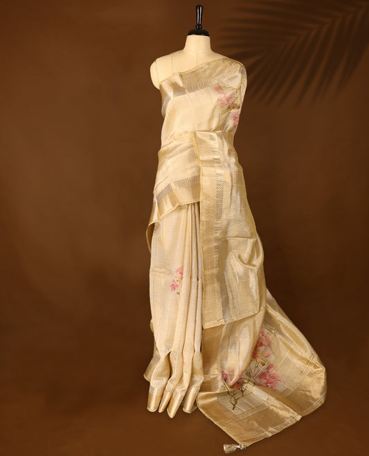 Radiant gold organza Kerala saree adorned with delicate floral accents, a shimmering zari border and a matching blouse