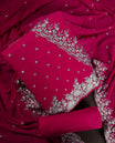 Pinkish red colour churidhar material adorned with elegant golden floral embroidery and delicate motifs, paired with a matching embroidered dupatta and plain bottom.
