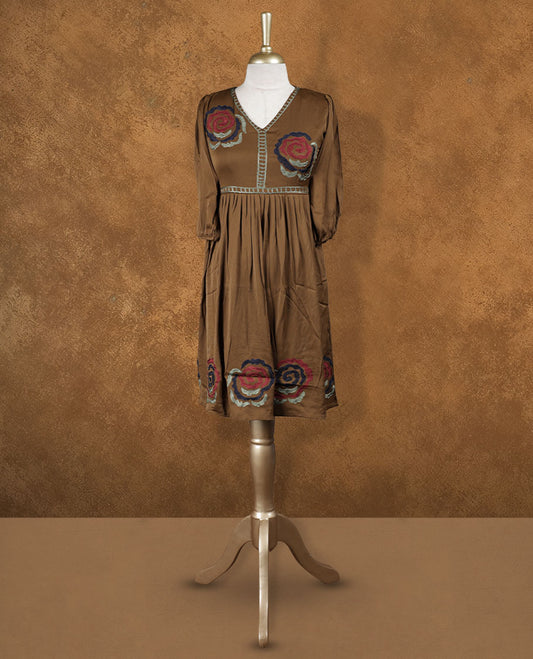 Mocha brown knee-length A-line dress with V-neckline, bold floral embroidery on yoke and hem, and elbow-length gathered sleeves.