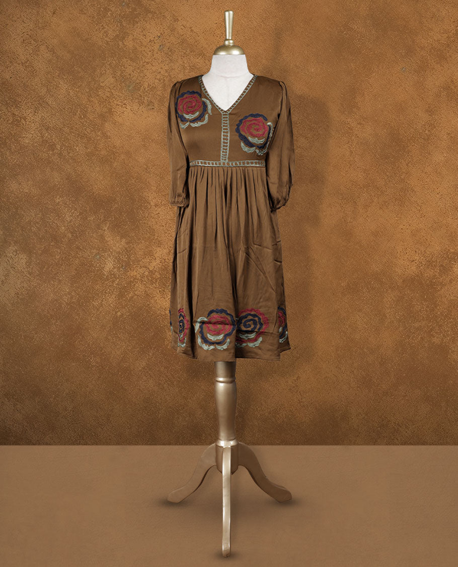 Mocha brown knee-length A-line dress with V-neckline, bold floral embroidery on yoke and hem, and elbow-length gathered sleeves.