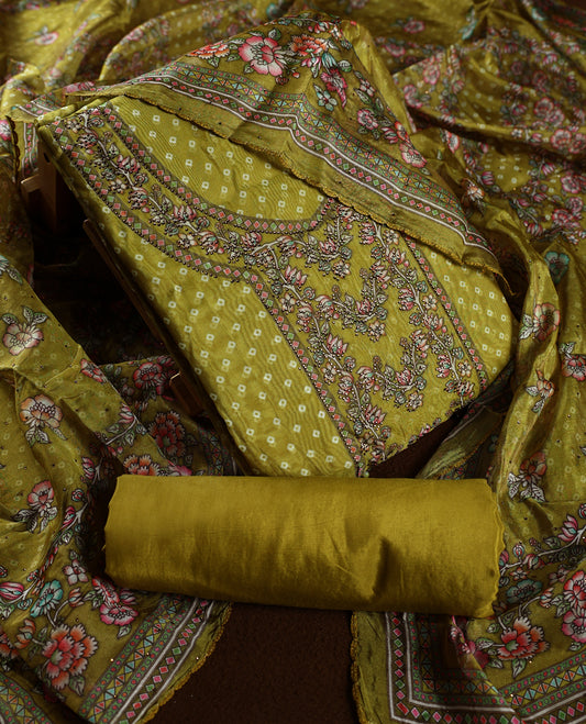 Mustard yellow churidhar material beautifully designed with intricate floral, stone and vine prints, paired with a matching plain bottom and elegant printed dupatta, perfect for festive and traditional wear.