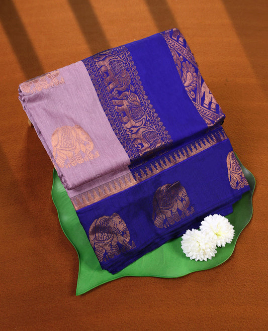 Dual shade Lavender and Royal Blue Kalyani cotton saree featuring intricate zari woven elephant motifs across the body, complemented with a rich zari border and pallu, paired with a matching blouse.