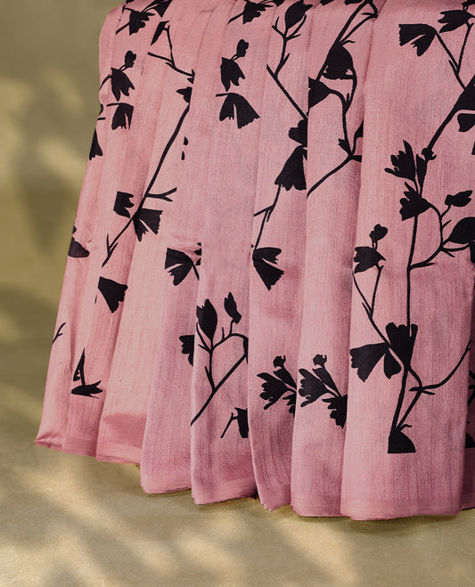 Pastel onion colour semi printed saree featuring black florak kodi prints across the body, finished with a sleek plain border, with matching blouse