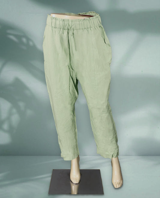 Light sage green colour women's pants feature a relaxed, ankle length fit with an elastic waistband, subtle pleats, and side pockets