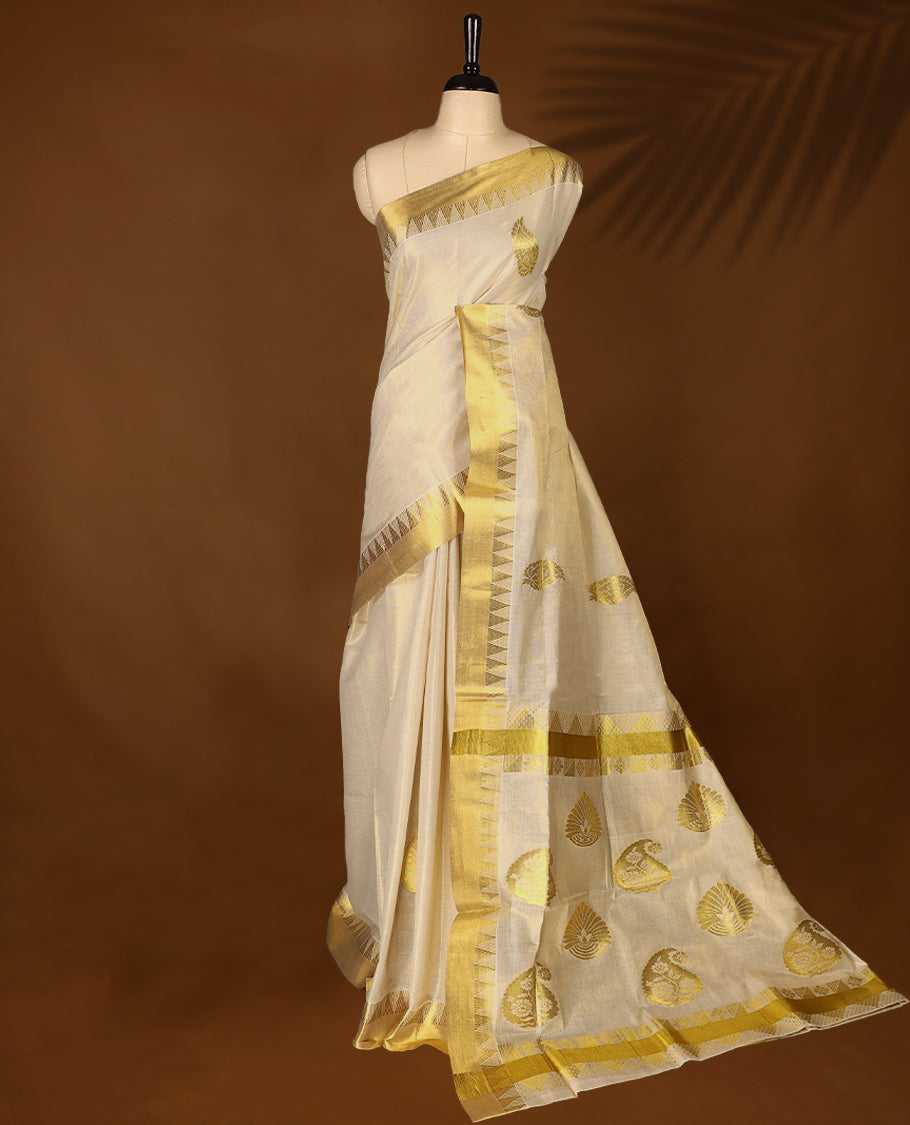Elegant Light Gold colour Tissue Kerala saree featuring Gold Zari Motifs on body, traditional golden zari kasavu border & Rich Pallu offering a classic and graceful look, paired with a matching blouse.
