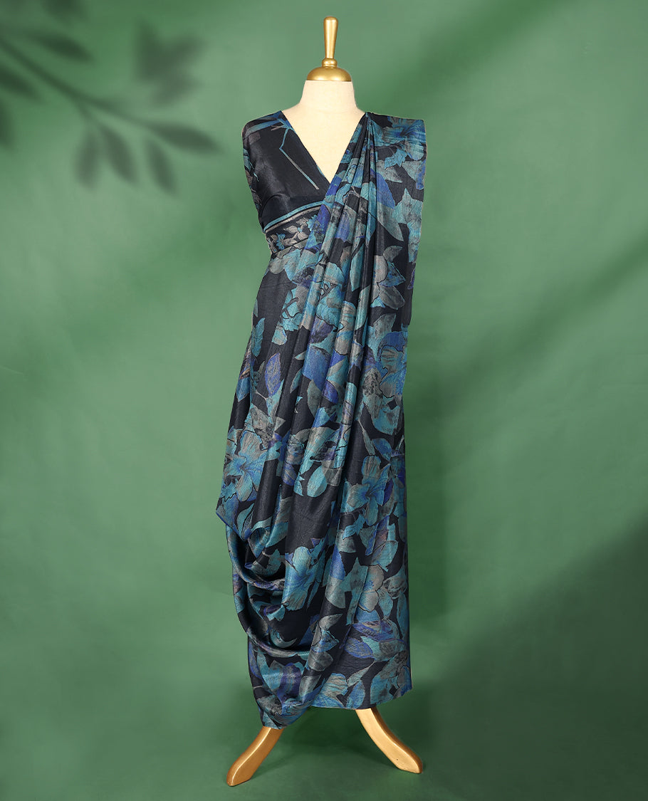 Charcoal black colour Manipuri saree featuring oversized teal and indigo floral motifs, finished without a border, and paired with a matching blouse.