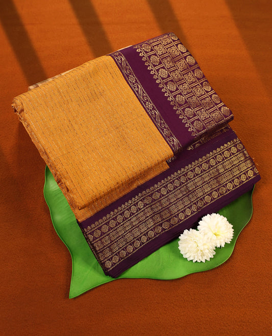 Bright Mustard colour mixed Kalyani cotton saree featuring Gold zari checks throughout the body, paired with Deep Grape colour traditional border and pallu, with matching blouse