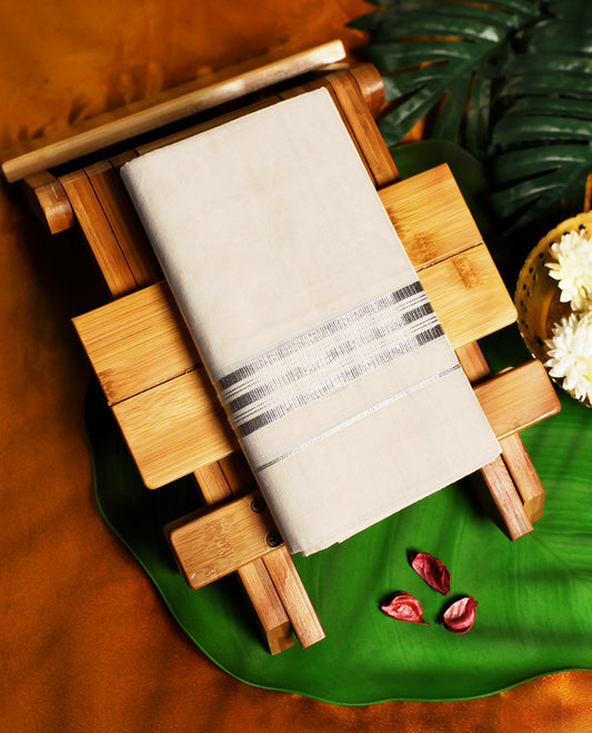 Elegant off white colour pure cotton dhoti accented with a refined silver zari border, blending simplicity with tradition, ideal for temple wear, festive occasions, and cultural celebrations.