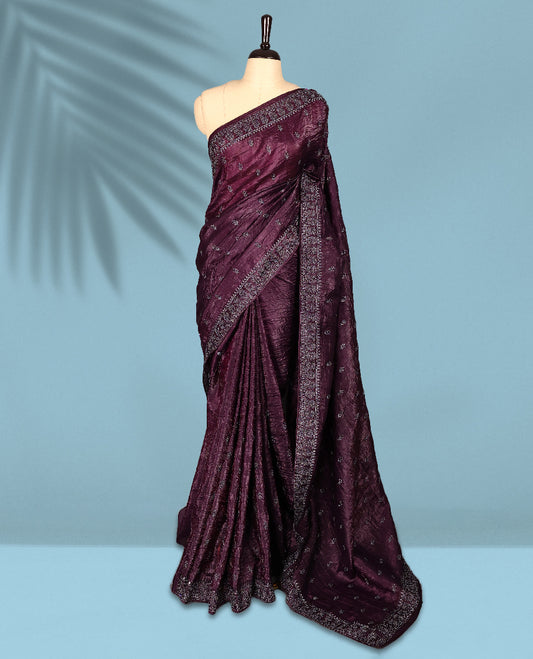 Deep Grape Colour crush soft silk saree, textured body with a natural crinkled finish, adorned with intricate Silver colored floral Motifs and complemented by a delicate Silver Zari embroidery border, paired with a matching blouse