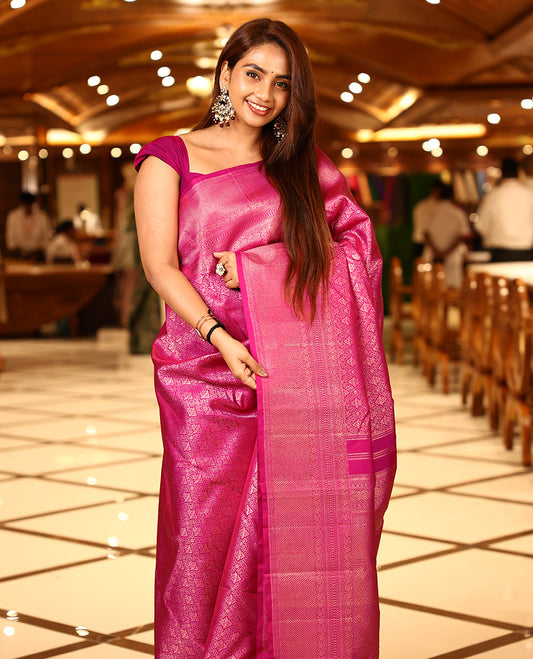 Deep magenta colour pure Kancheepuram brocade silk saree featuring a brocade body, antique brocade border with nellikamalam and mayilkannu motifs, diamond and kodivishari woven pallu, paired with a diamond-patterned brocade blouse.