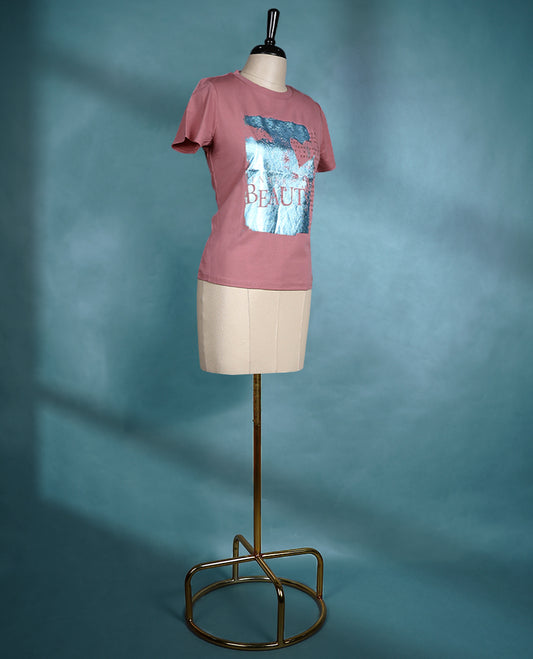 Dusty pink colour T shirt featuring short sleeves, a round neck, and a metallic blue graphic print for a stylish casual look.