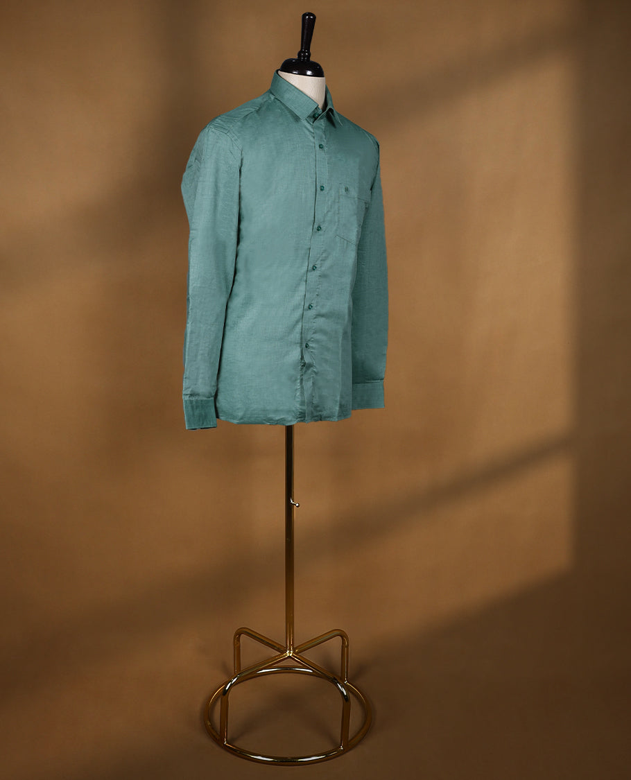 Dusty teal green colour OTTO men’s shirt in a relaxed formal fit featuring a subtle self textured body, classic collar, full sleeves, and front chest pocket ideal for office or smart casual wear.
