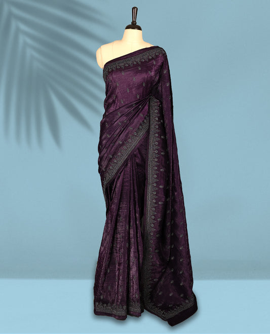 Deep Grape Colour crush soft silk saree, textured body with a natural crinkled finish, adorned with intricate Silver colored Flower like Motifs and complemented by a delicate Silver Zari embroidery border, paired with a matching blouse