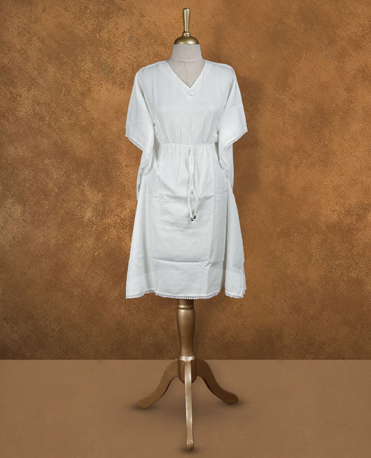 White kaftan-style nightwear dress with V-neckline, drawstring waist tie, relaxed draped sleeves, and delicate lace-detailed hem and edges.