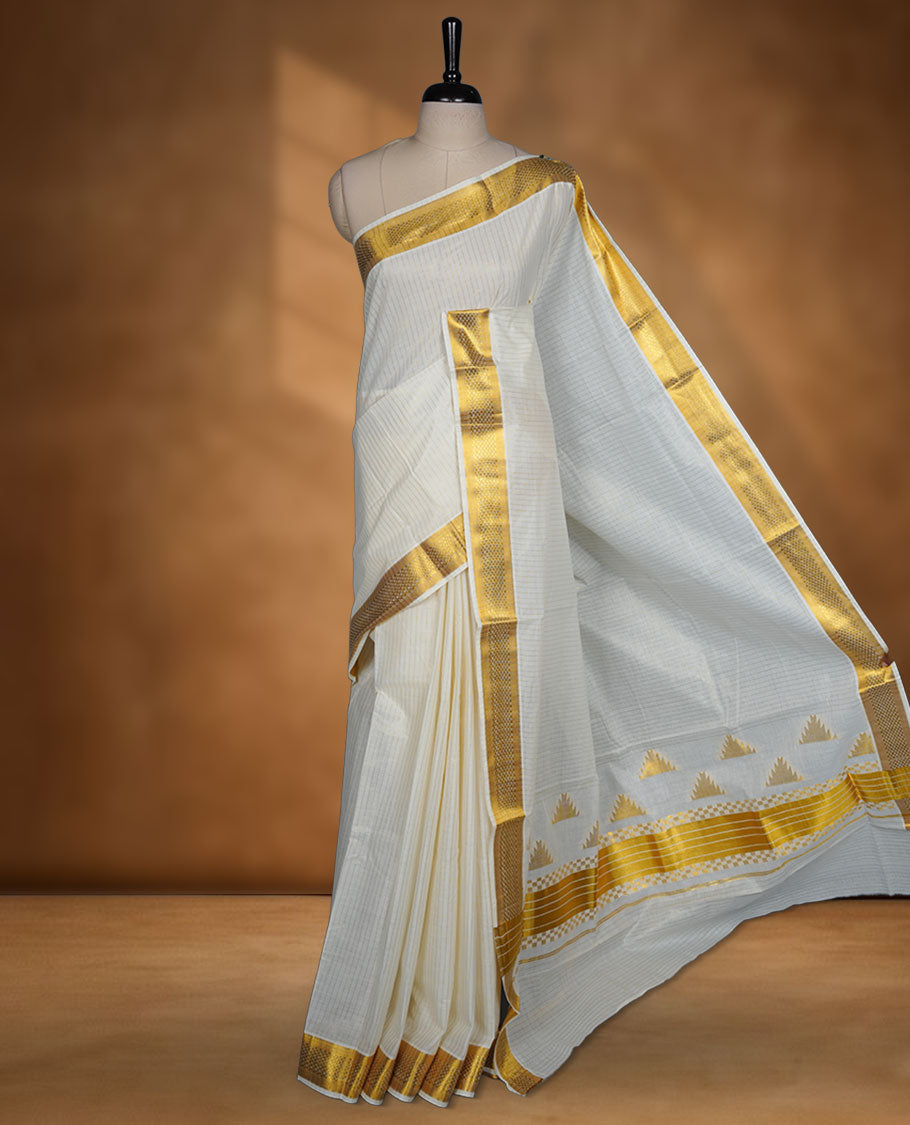 Off-white colour Kerala cotton saree with fine striped texture, rich golden zari border, and traditional motif pallu, paired with a matching blouse.