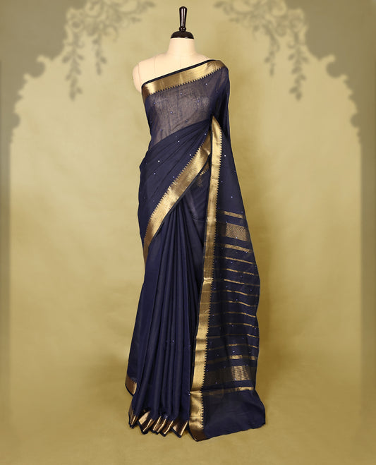 Navy Blue colour Chanderi cotton saree featuring a subtly textured body with delicate buti work, complemented by a rich golden zari border with matching blouse
