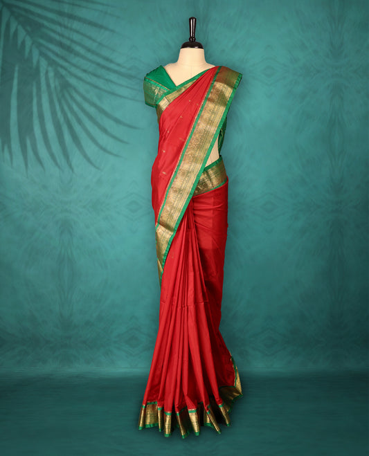 Deep Red colour Traditional Kancheepuram Silk saree with small gold motifs on body, Green traditional border with intricate gold zari weaving, grand zari pallu, perfect for Bharatanatyam, with matching blouse.