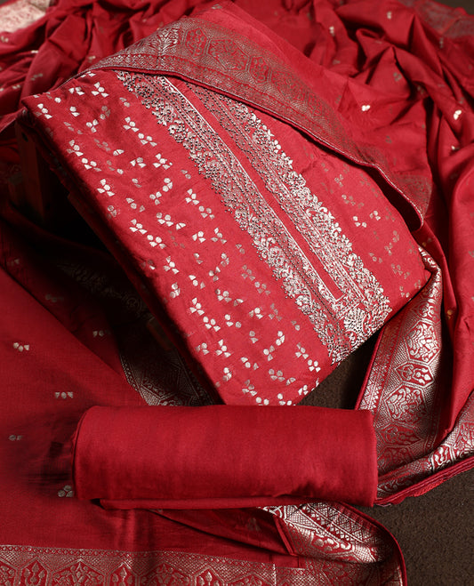 Reddish Brown churidhar material adorned with golden zari woven motifs and an elegant traditional border, paired with a plain matching bottom and grand dupatta, perfect for weddings, festive occasions, and celebrations.