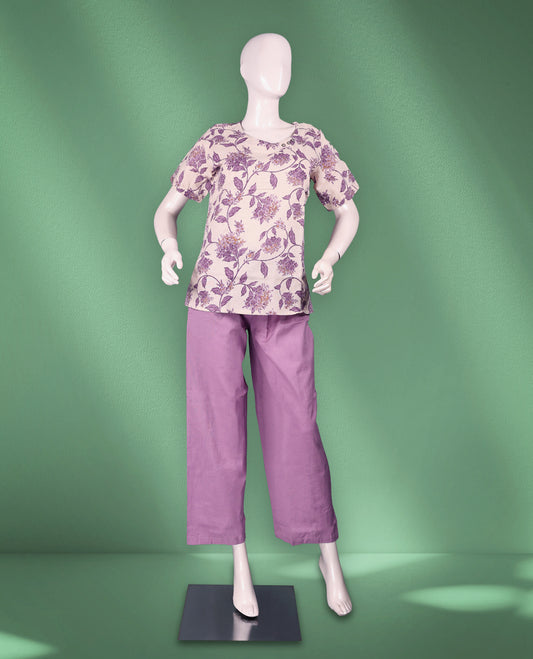 Pastel Purple colour women's nightwear set featuring a round-neck floral-printed top with short short sleeves, paired with solid straight-fit pants for a stylish and cozy appeal.