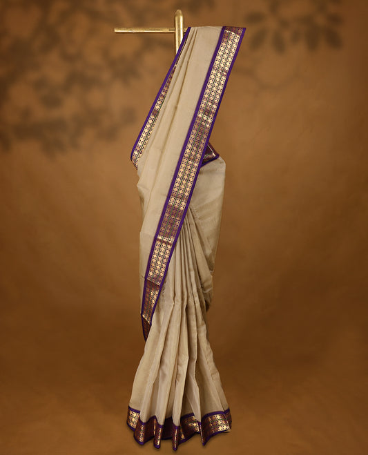 Beige Colour soft silk saree with a plain body, highlighted by a striking contrast Poun design border paired with a plain blouse in a matching contrasting tone