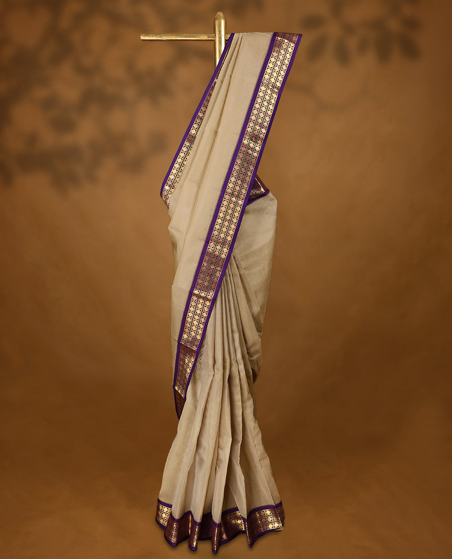 Beige Colour soft silk saree with a plain body, highlighted by a striking contrast Poun design border paired with a plain blouse in a matching contrasting tone