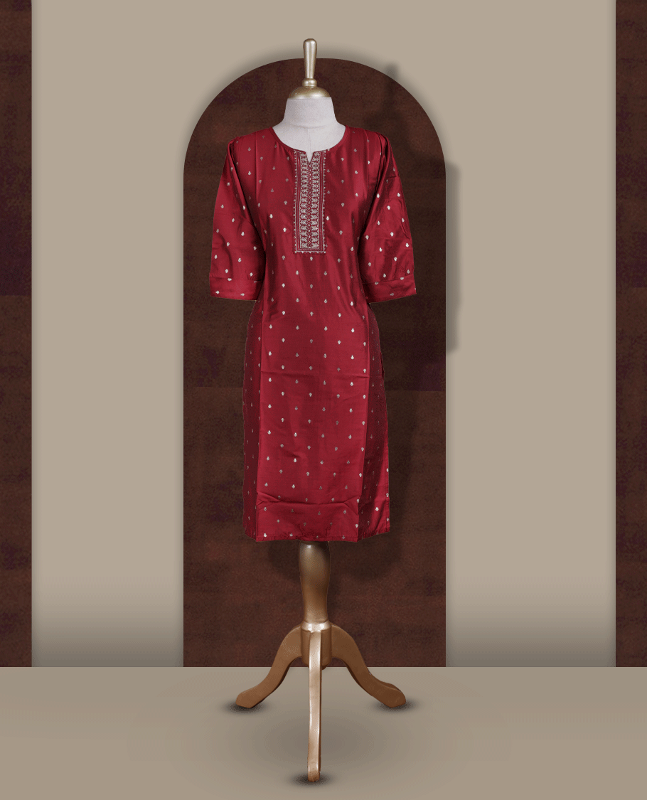Deep maroon colour kurti from TWARA, adorned with subtle elegant motifs and intricate embroidery on the neckline, finished with a round neck and elbow length sleeves.
