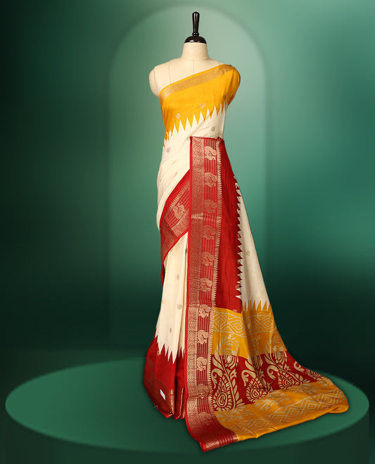 Cream and yellow colour saree featuring a rich red zari woven border and pallu, adorned with traditional floral motifs, and paired with a matching blouse