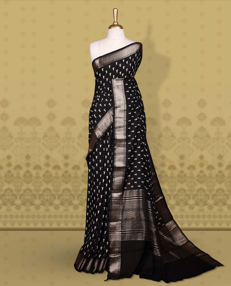 Black colour saree adorned with elegant white floral prints and a rich black zari border and rich stripped pallu & Comes with a matching blouse piece.