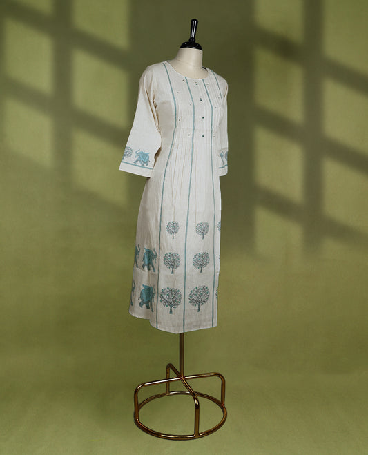 Beige colour kurta with a round neck and 3/4th sleeves, detailed with teal vertical pintucks, delicate embroidery, and block printed tree motifs.