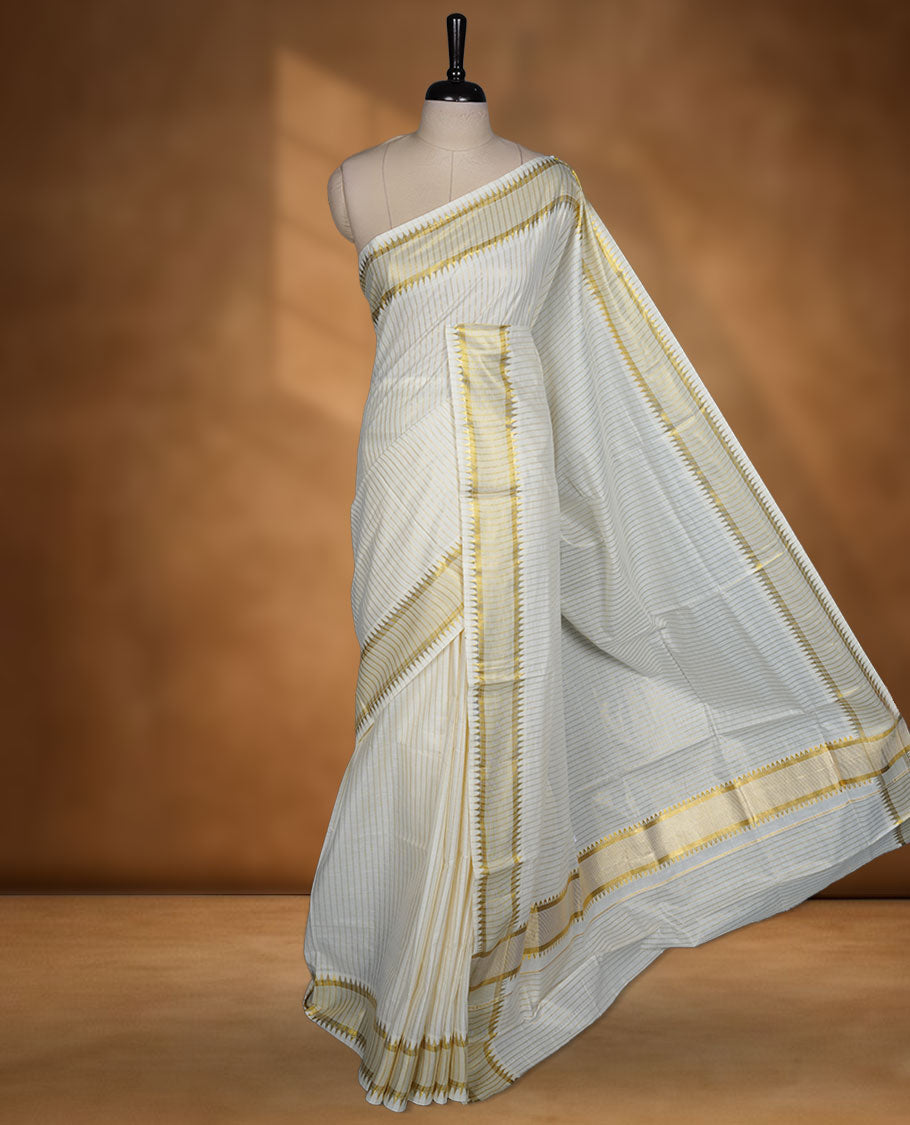 Off white colour cotton Kerala saree featuring fine golden striped motifs, complemented by a classic golden zari border and traditional pallu, paired with a matching blouse.