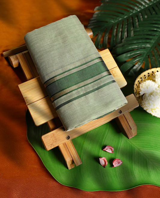 Soft green colour pure handloom double dhoti featuring a rich green kara with subtle golden zari weaving, crafted with fine traditional detailing for elegance, comfort, and cultural occasions.