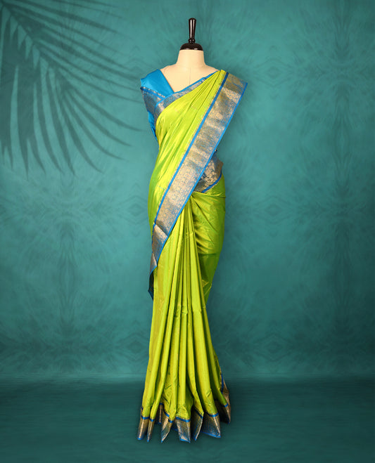 Neon Green colour Traditional Kancheepuram Silk saree with small gold motifs on body, Blue traditional border with intricate gold zari weaving, grand zari pallu, perfect for Bharatanatyam, with matching blouse.