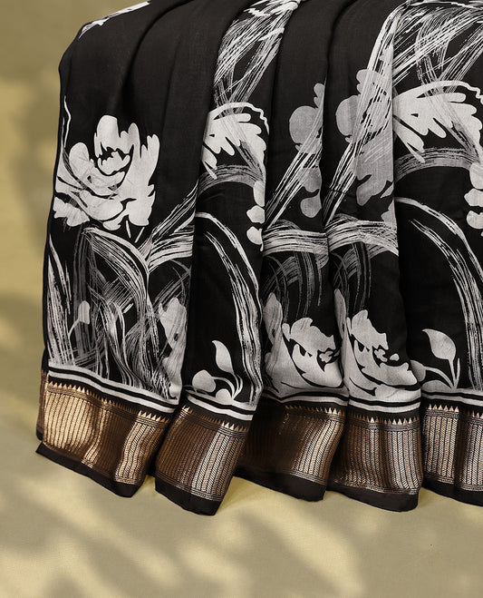 Black colour Viscos semi printed saree featuring a golden zari border, abstract white printed motifs on the body, and comes with a matching blouse