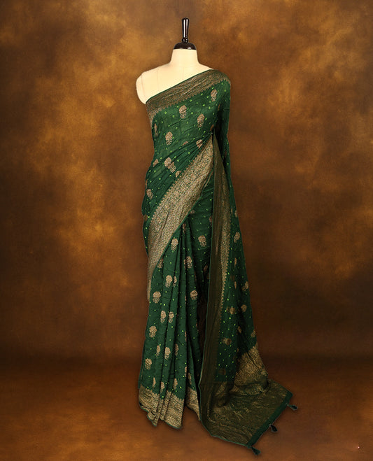 Deep green colour Banarasi Bandhani silk saree featuring light parrot green hand Bandhani patterns with intricate Banarasi motifs, complemented by antique zari woven border and grand pallu, paired with matching antique zari brocade blouse.