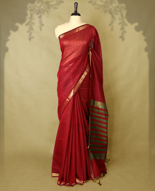 Deep Red colour chanderi cotton saree with fine striped body, mangalgiri border, grand pallu featuring olive Green and gold zari stripes, with matching blouse.